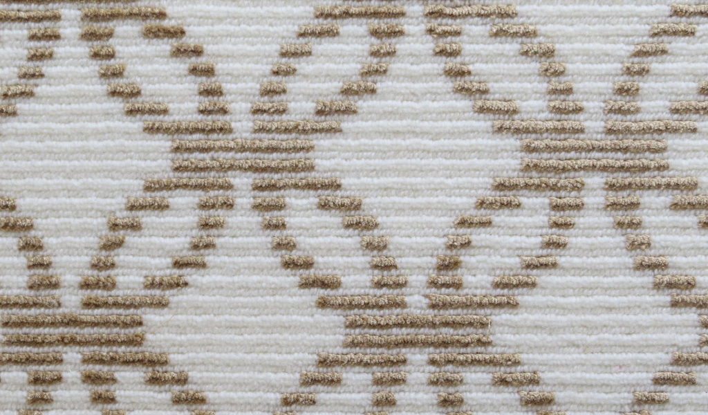 Rialto, Color: Limestone 21/5221 color swatch. Rialto is cut/loop wilton fabricated with 50% tencel and 50% wool yarns in colors of white and lt camel. The yarns create a design motif that resembles interconnected circles.
