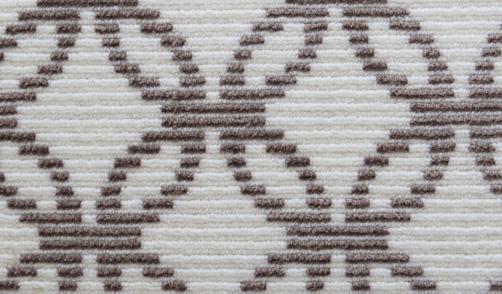 Rialto, Color: Umber 25/5222 color swatch. Rialto is cut/loop wilton fabricated with 50% tencel and 50% wool yarns in colors of white and brown. The yarns create a design motif that resembles interconnected circles.