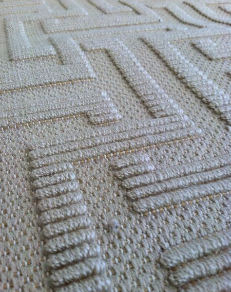 Xenia, Color: Lt Gold 28/8002 is comprised of tencel. Image shows a close up of Xenia's high/low graphic pattern in a loop construction.