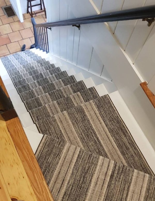 Linen Stripe,, Color: Charcoal Silver 31/5703 installation by Cape Cod Custom Floors, ocated in Hyanni, MA. Linen Stripe, Color Charcoal Silver 31/5703 installed on stairwell by Cape Cod Custom Floors, located in Hyannis, MA. Linen Stripe has stripes that run the length of the carpet/stairwell. This colorway has hues of charcoal, silver and white.