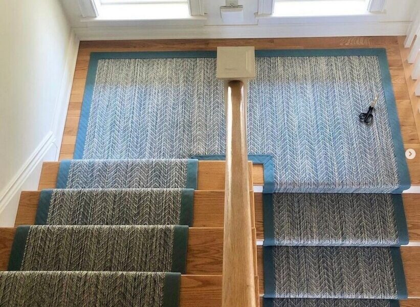 Riverbed bordered stair runner, Color: Shallow Water 41/5730. Imags shows carpet on stairs and scissors used as prop. Image credit: Bradford's Rug Gallery, Portland, ME