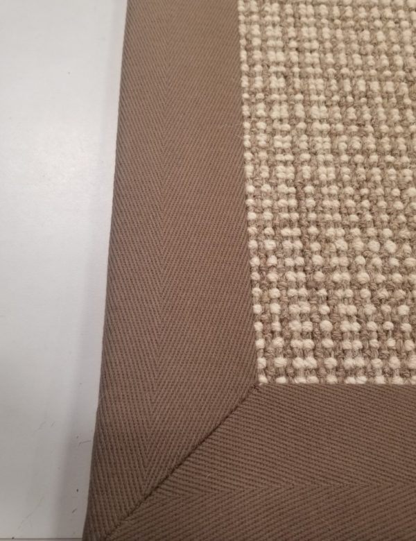 Grand Central rug, Color: Mink/Ivory 520/1501 with wide cotton binding Grand Central rug , Color: Mink/Ivory 520/1501 showing edges bound with cotton binding. Grand Central is a large plaid design