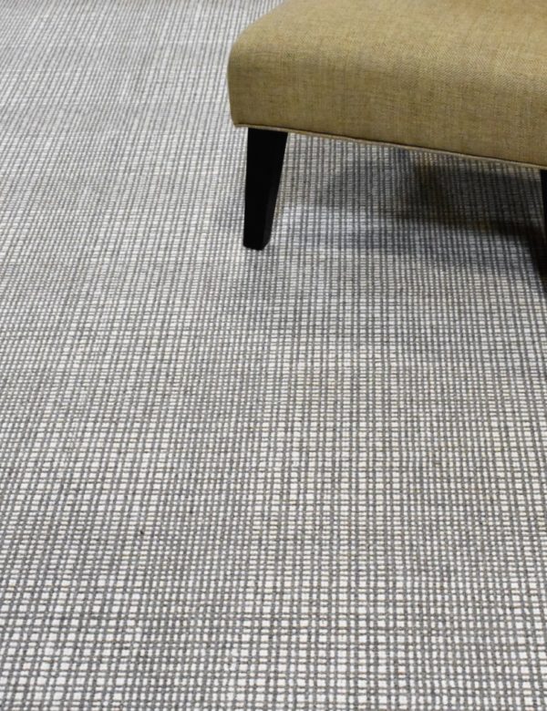 Grand Central, Color: Pewter Ivory 530 / 1501 shown with chair. Grand Central, Color: Pewter Ivory 530/1501 shown with chair. Grand Central Pewter Ivory is hand loomed with two hearthered yarns (pewter/ivory) creating a large plaid design.