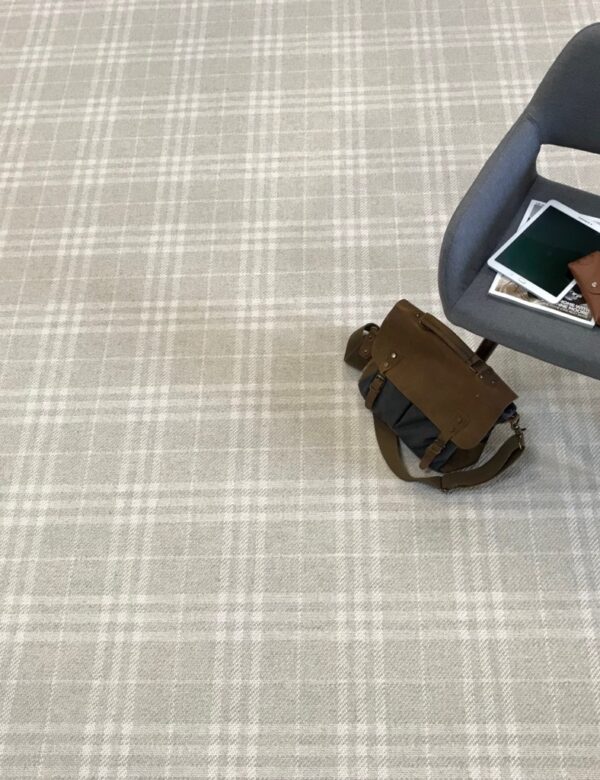 Glencoe, Color: Etched Glass 1015F/5712F with props Glencoe, Color: Etched Glass 1015F/5712F shown with chair, tablet and cross-body bag as props. Glencoe is flatwoven plaid design with 2 colors (beige and white).