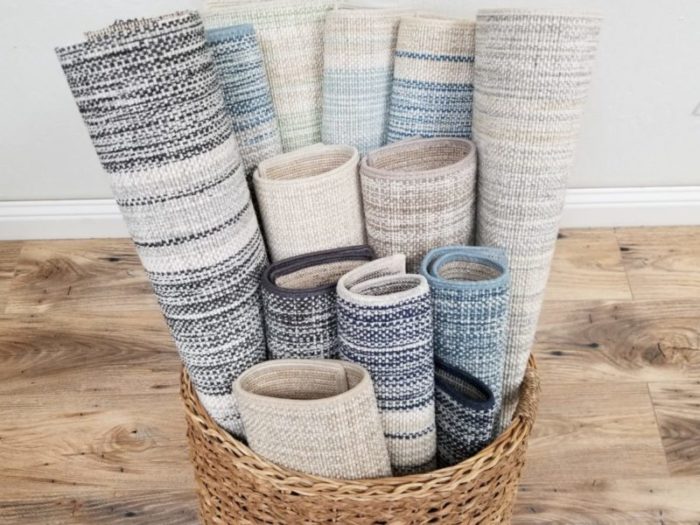 Linen Collection featuring various designs and colors. Designs shown are Linen 5700, Linen Band 5702 and Linen Stripe 5703. Image shows samples placed in a wicker basket.