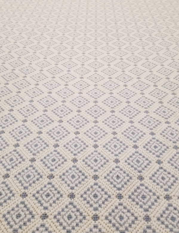Dahlia, Color: Beryl Blue 27/8014 Dahlia, Color: Beryl Blue 27/8014 showing several repeats. Dahliia is small diamond pattern, with two colors, that repeats across the carpet