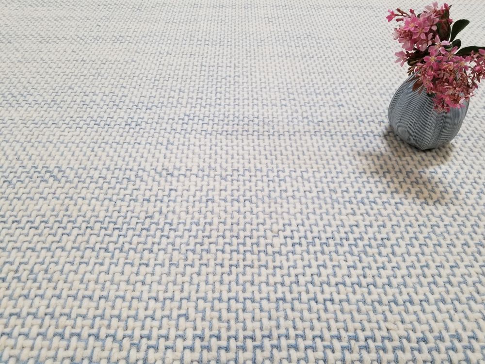 Trace, Color: Blue / Lt Blue 406/1518 shown with vase and flowers. Trace has a natural white background with blue yarns tracing along the weave structure.