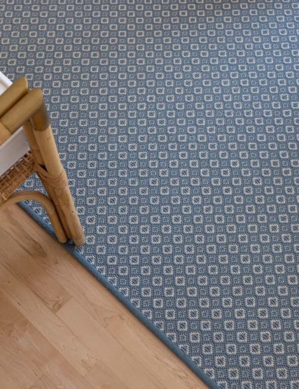 Savina, Color Lt Denim 17/5744 rug with props Savina, Color: Lt Denim 17/5744 rug shown with chair. Savina is an intricate small diamond motif.