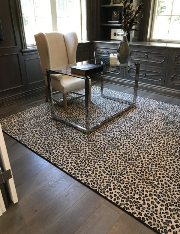 New Kraal Leopard II rug, Color: Grey 41/6406B with serged finishing. Image courtesy of The Beaubelle Group, Orinda, CA. New Kraal Leopard II rug , Color: Grey 41/6406B in den/ofice, with furnishings. New Kraal leopard is a leopard animal design. Image courtesy of The Beaubelle Group, Orinda, CA.