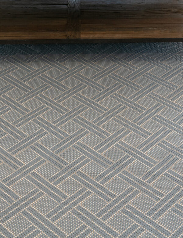 Brisa, Color: Lt Denim 17//5740 close view with table used as prop. Note: Lt Denim is available as custom color only - minimum qty 35 LF Brisa, Color: Lt Denim 17//5740 close view with table and chairs used as props. Brisa Lt Denim is fabricated with 2 yarn colors, denim and white, woven together to create an open basket-weave pattern.