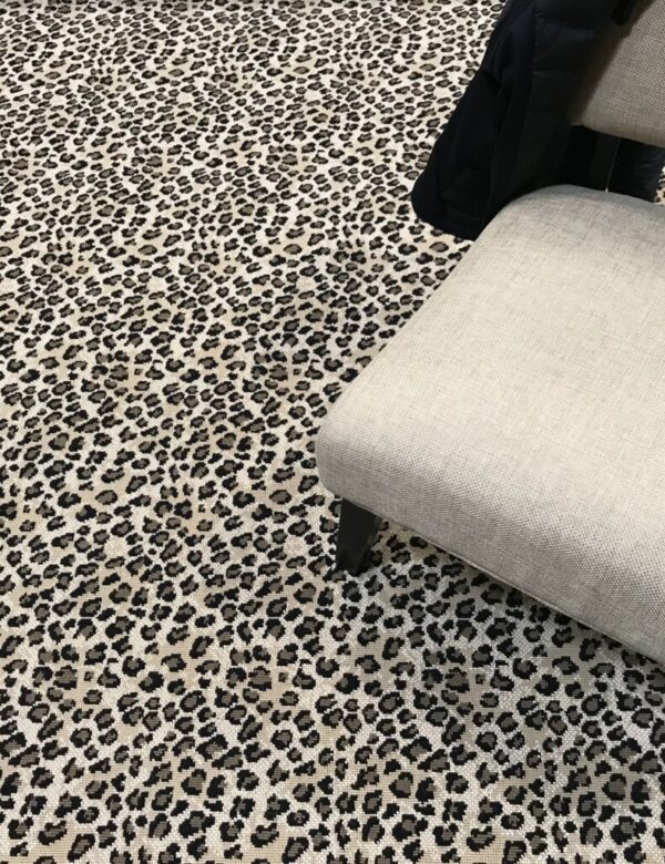 New Kraal II, Color: Classic 47/68046B shown with chair used as prop. This carpet has a leopard design. New Kraal II Leopard, Color: Classic 47/68046B shown with chair used as prop. This carpet has a leopard design.