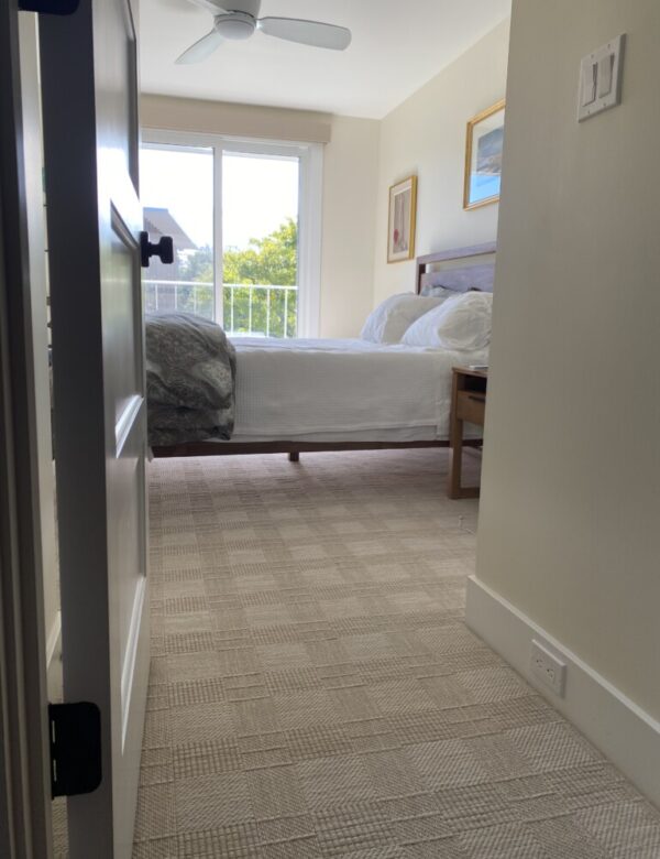 Crossings, Color: Branches 21/5770 installed in furnished bedroom. Crossings, Color: Branches 21/5770 installed in furnished bedroom. Crossings has a grid/block design with a striated ground.