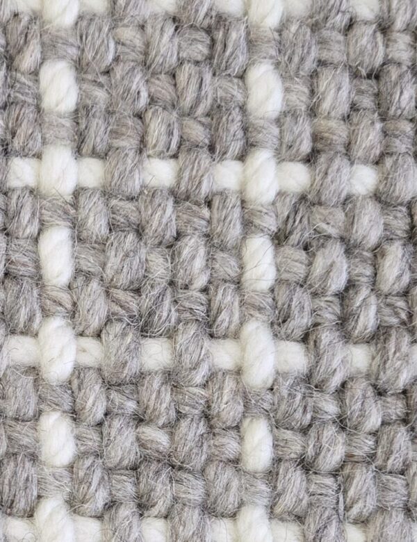 Boulevard, color: Ash 742/1564 showing close view Boulevard, color: Ash 742/1564 showing close view. Boulevard is broadloom with a grid-like pattern created by a background of grey heathered yarns and white top-stitch.