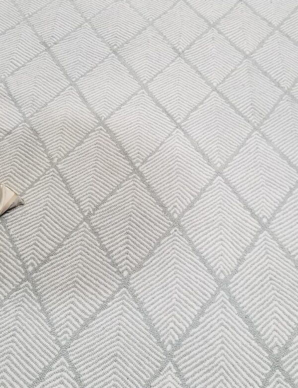 Pinnae, Color: Spearmint 670/1516 Pinnae, Color: Spearmint 670/1516 shown with table leg and pillow used as props. Pinnae is a large diamond design constructed with two colors.